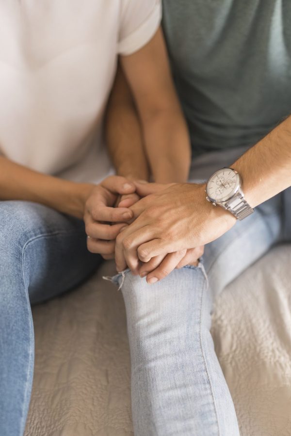 crop-couple-touching-hands-bed-scaled-1.jpg
